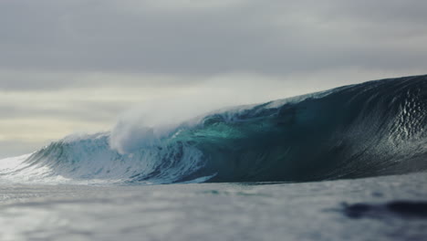 Strong-forceful-wall-of-water-crashes-into-white-wash-barrel-with-ocean-mist-spraying