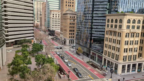Aerial-panoramic-street-view-in-business-center-of-Oakland-City-California-urban-landscape-in-calm-morning,-roads-pedestrians-and-cars-passing-by