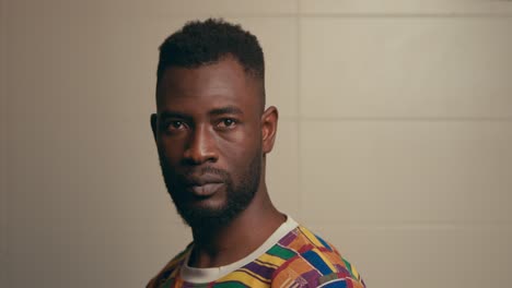 Portrait-Of-Bearded-Young-African-American-Man-Turning-His-Head-And-Looking-At-The-Camera