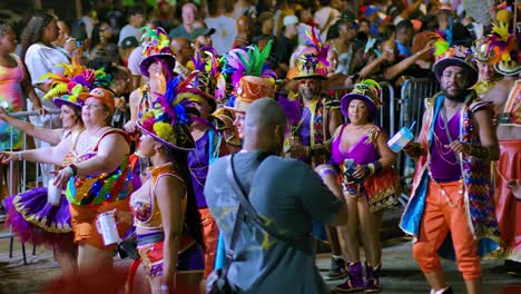 Photographer-walks-backward-taking-pictures-of-Carnival-performers-dancing-in-parade