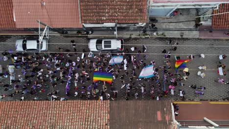 Women's-Day-protestors-march-down-narrow-cobbled-street-in-Bolivia