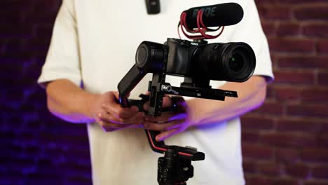Filmmaker-adjust-and-balance-electronic-gimbal-axis-with-digital-camera-attached