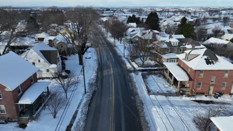 Aerial-establishing-shot-of-traffic-on-a-rural-road