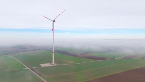 Wind-Turbine-With-Red-Stripes-In-The-Farm-On-A-Foggy-Day