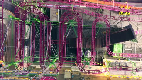 Colorful-roller-coaster-in-an-Italian-amusement-park-during-blue-hour,-lights-off