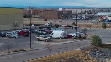 Semi-truck-and-trailer-drive-to-warehouse-with-steel-beams