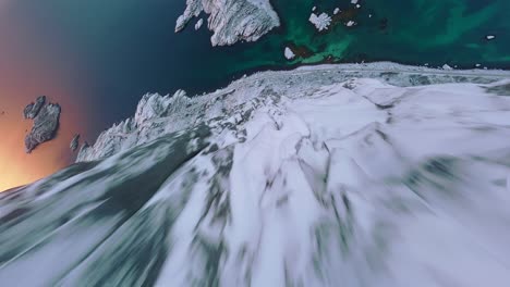 FPV-Drone-flight-down-a-mountain-in-Lofoten,-Norway