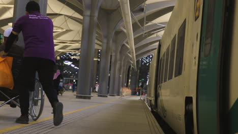 Person-in-a-wheelchair-boarding-the-high-speed-train-in-Medina,-Saudi-Arabia