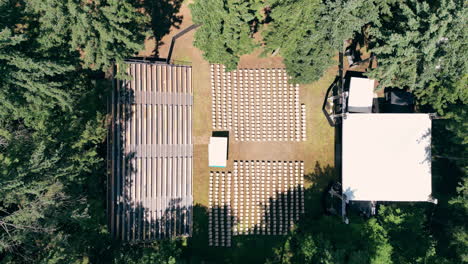 Overhead-Aerial-View-of-a-open-air-concert-stage-Surrounded-by-Trees