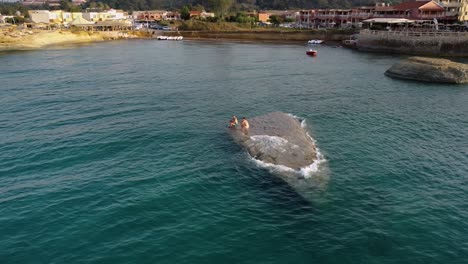 Canal-D'Amour-Beach-Bay-with-two-Mans-Exploring-Submerged-Rock,-Corfu,-Greece