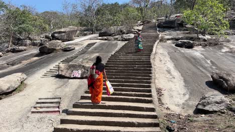 Woman-climbing-mountain-in-Maa-Kauleshwari-Temple,-Chatra-in-Jharkhand