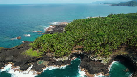Aerial-view-rising-over-the-Ilheu-das-Rolas-island,-sunny-day-in-Sao-Tome,-Africa