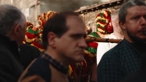 Mystic-Caretos-parade-Amidst-the-Crowd-during-folk-Carnival,-Podence-Portugal