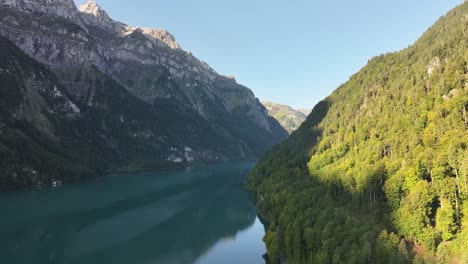 Mountain-lake-in-Klöntalersee-with-Vorderglärnisch-peak,-Glarus,-Switzerland,-tranquil-nature-scene,-aerial-shot