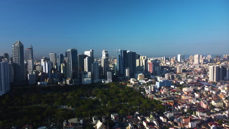 South-cemetary-and-the-Makati-skyline-in-Metro-Manila,-Philippines---Aerial-view