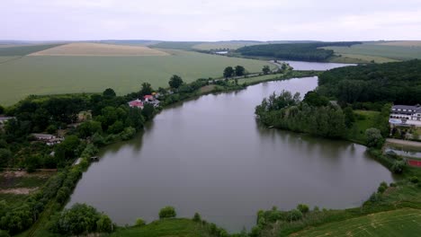 Trei-Iazuri-Inn,-Iasi-County,-Romania---The-Inn-Situated-on-the-Edge-of-One-of-the-Three-Ponds---Aerial-Drone-Shot