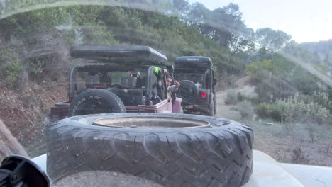 Three-offroad-Jeep-4x4-cars-with-rooftop-camping-tents,-fun-outdoors-ATV-adventure-friends-trip-in-Marbella-Malaga-Spain,-4K-shot