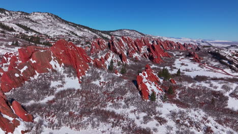 March-winter-morning-after-snowfall-stunning-Roxborough-State-Park-Littleton-Colorado-aerial-drone-landscape-sharp-jagged-dramatic-red-rock-formations-Denver-foothills-front-range-blue-sky-circle-left