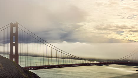 Time-Lapse,-North-Tower-of-Golden-Gate-Bridge,-Clouds-and-Fog-Moving-Above-San-Francisco-Downtown-and-Bay