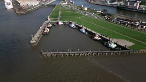 many-tug-boats-on-a-little-port,-Bremerhaven,-germany,-europe,-drone,-north-sea