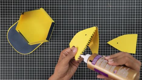 Gluing-paper-art-for-handmade-cap,-crafts-close-up