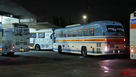 Passenger-bus-moving-backwards-and-moving-to-the-right-side-of-the-frame-to-get-out-of-Mochit-Bus-Terminal,-going-to-its-destination-outside-of-Bangkok,-Thailand