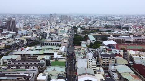 A-dense-urban-area-with-mixed-residential-and-commercial-buildings,-aerial-view