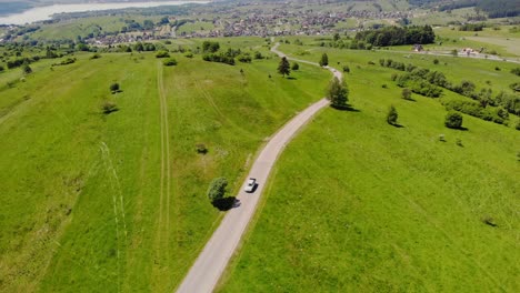 Drive-through-pasture-and-meadow-on-summer-voyage,-countryside-getaway,-aerial