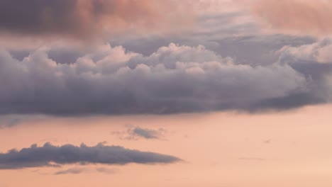 Densas-Nubes-Giran-En-El-Cielo-Del-Atardecer-Iluminado-Por-El-Cálido-Resplandor