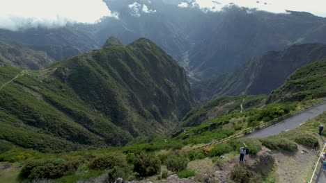 Tourists-moving-around-at-scenic-Madeira-Lombo-do-Mouro-viewpoint,-aerial