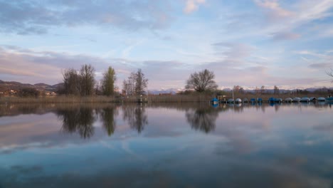 Beautiful-sunset-on-a-lake-with-mountains-in-the-background-and-boats-on-the-lake