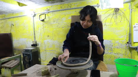 Mexican-craftswoman-cleaning-a-big-rounded-base-in-which-she-is-going-to-make-a-clay-figure