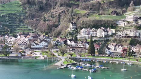 Drone-clip-moving-towards-traditional-buildings-in-Weesen,-St-Gallen,-on-the-lakeside-shore-of-Lake-Walen