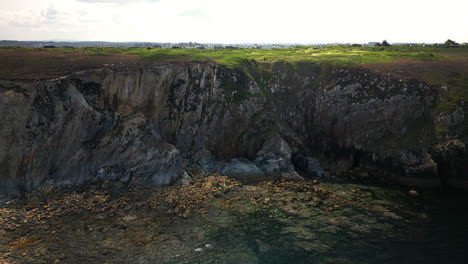 Aerial-View-of-Water-Body-and-Town-Separated-by-a-Cliff