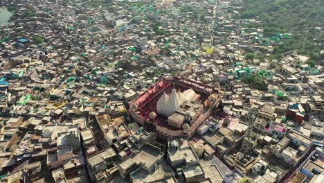 Aerial-drone-view-of-Don-Camaro-moving-forward-and-showing-a-large-temple-where-people-from-all-around-are-gathered-and-dancing-inside-the-large-temple