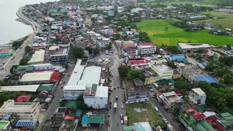 Overhead-aerial-dolly-of-quaint-provincial-town-with-old-buildings-and-busy-streets-in-Catanduanes,-Philippines