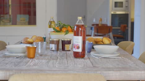 Slow-dolly-shot-revealing-food-and-juice-on-a-table-ready-for-a-breakfast