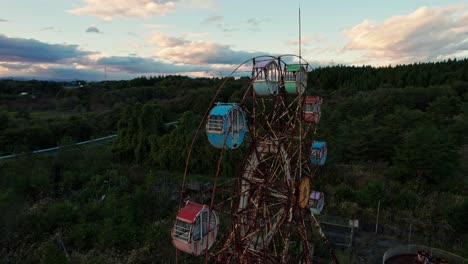 Closeup-Aerial-Drone-Abandoned-Ferris-Wheel-Kejonuma-Leisure-Island-Japan-Sunset-Panoramic-Landscape-of-overgrown-countryside,-asian-Travel