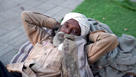 Cinematic-Shot-The-brother-from-the-slum-area-is-seen-sleeping-peacefully-and-is-looking-at-the-camera