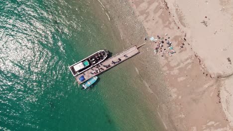 Luftdrohne-Von-Oben-Nach-Unten,-Fischerboot-Entlädt-Wakayama-Strand,-Japanisches-Meer,-Weißer-Sand-Und-Arbeiter-Und-Käufer-Während-Des-Sommertages,-Japanische-Küste