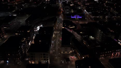 Night-time-above-city-center-of-Reykjavik-capital-of-Iceland,-aerial