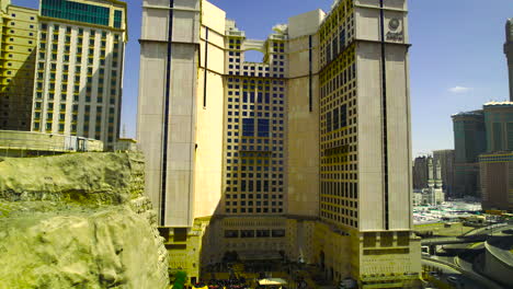 Drone-establishing-shot-of-tower-hotels-with-sandstone-and-black-gold-decorative-trim