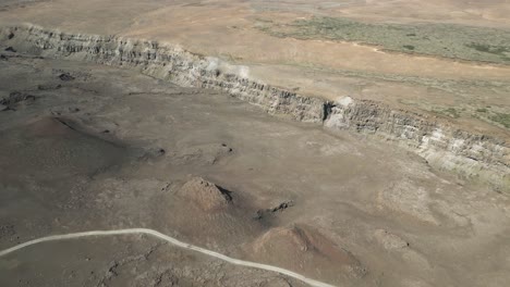 Dry-hot-dessert-following-aerial-shot-of-canyon-dried-up-river-near-Detifoss-Waterfall-In-Iceland