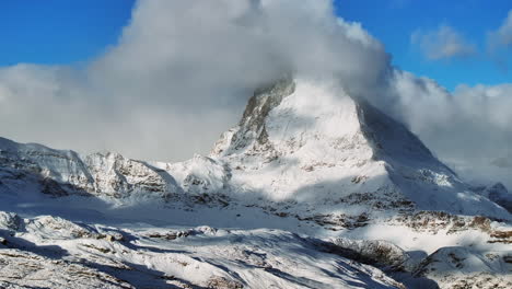 First-fresh-snowfall-dusting-early-morning-close-up-fog-Matterhorn-Zermatt-Glacier-peak-landscape-scenery-aerial-drone-autumn-Swiss-Alps-top-of-summit-Gornergrat-Railway-Switzerland-left-circle-motion