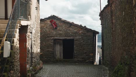 Solitary-Carnival-Mask-on-Rustic-Podence-Village-Wall,-Portugal