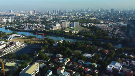 Aerial-view-over-Makati,-toward-the-Mandaluyong-cityscape,-in-Manila,-Philippines