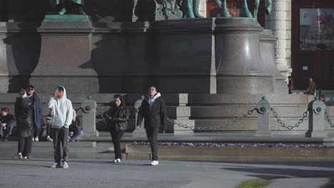 Fixed-Shot-Of-People-Walking-In-Front-Of-Hofburg-Former-Principal-Imperial-Palace,-Vienna