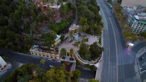 Aerial-drone-Fly-Santa-Lucia-Hill-Main-Entrance-at-Neptune-Fountain-Santiago-de-Chile-Streets-neighborhood-at-daylight
