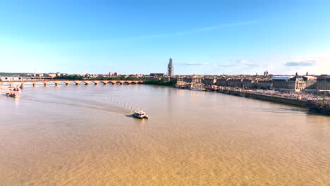 Garonne-River-with-riverboat-and-large-galleon-ship,-Aerial-pan-right-shot