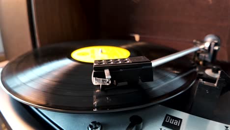 A-vinyl-record-spins-on-a-working-record-player,-close-up-view